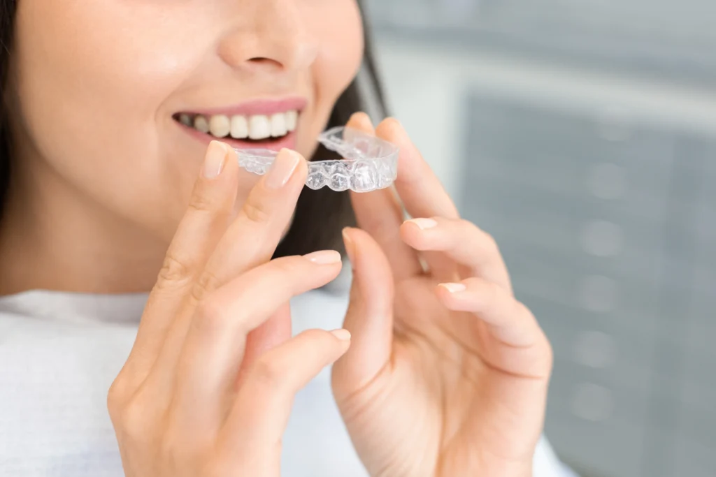 a woman doing clear aligner Invisalign alternative treatment at shining smiles orthodontics in irvine ca