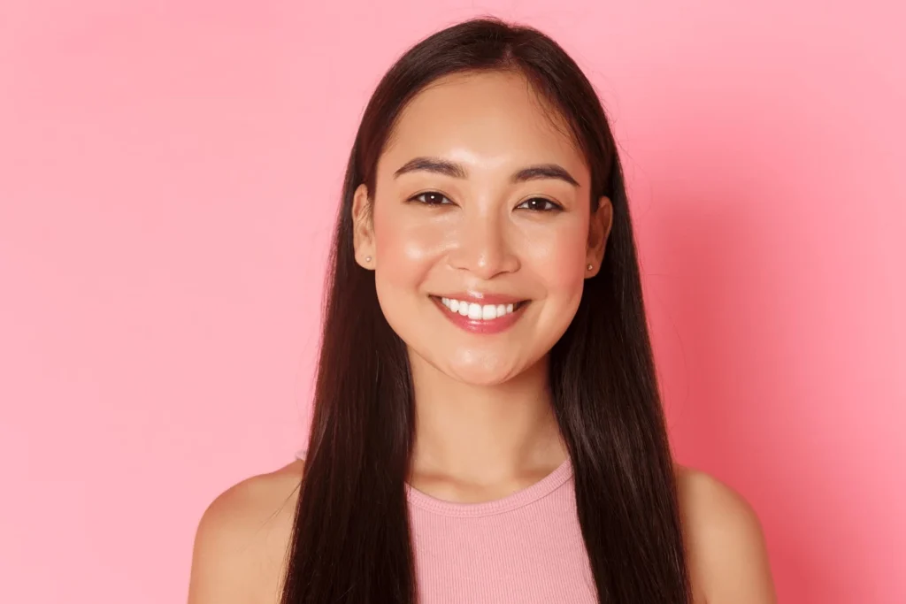 a woman with straight teeth after smining smiles orthodontics gave her adult orthodontist treatment in irvine ca